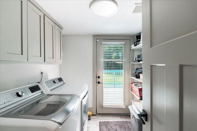 5701 Ave G, Austin, TX 78752 - laundry room with cabinet space, washer and clothes dryer, and light wood-type flooring