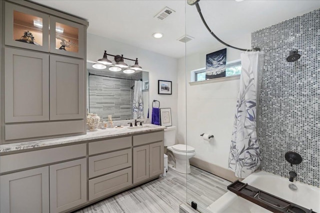 5701 Ave G, Austin, TX 78752 - bathroom featuring double vanity and shower / tub combo with curtain