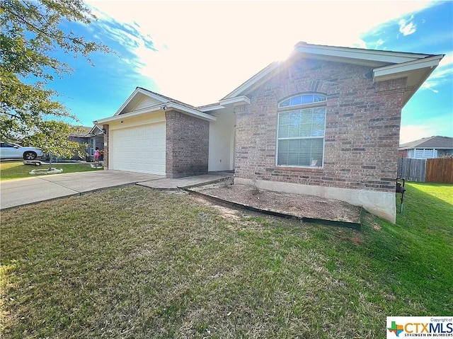 1119 Burgess Dr, Leander, TX 78641 - view of front of house featuring a garage, concrete driveway, and brick siding