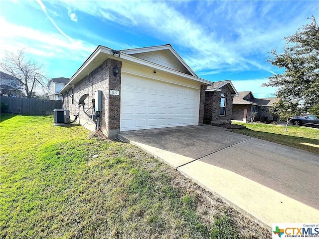 1119 Burgess Dr, Leander, TX 78641 - view of side of property with brick siding, driveway, and an attached garage