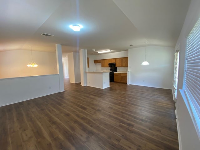 1119 Burgess Dr, Leander, TX 78641 - unfurnished living room with vaulted ceiling, a chandelier, and dark wood-style flooring