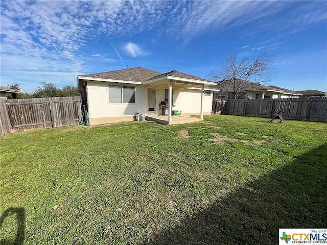 1119 Burgess Dr, Leander, TX 78641 - back of property with a patio area, stucco siding, and a fenced backyard