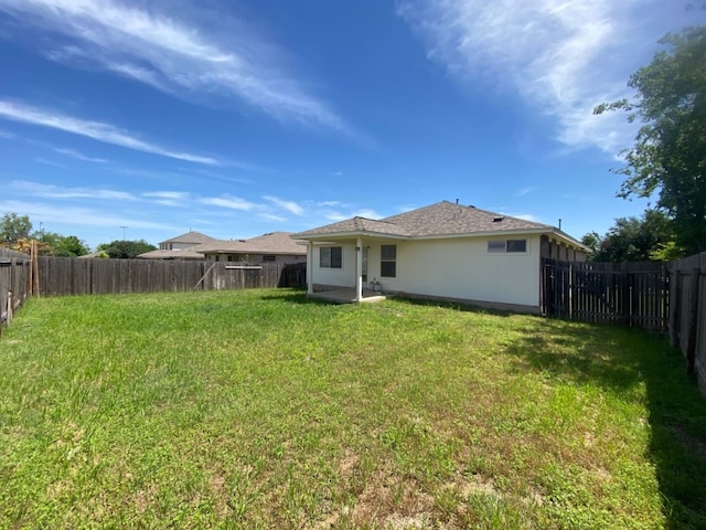 1119 Burgess Dr, Leander, TX 78641 - rear view of property with a fenced backyard, a patio area, and stucco siding