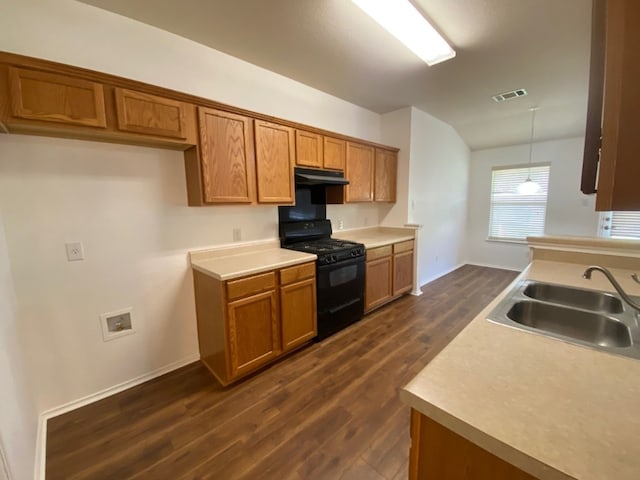 1119 Burgess Dr, Leander, TX 78641 - kitchen featuring black range with gas cooktop, brown cabinets, dark wood-style floors, and under cabinet range hood