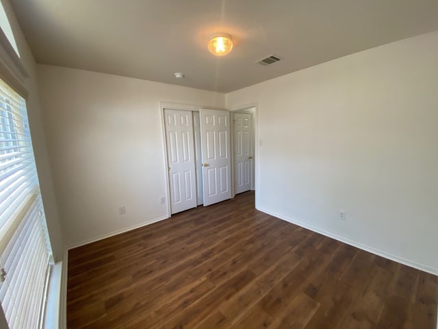1119 Burgess Dr, Leander, TX 78641 - unfurnished bedroom featuring dark wood-style flooring and a closet
