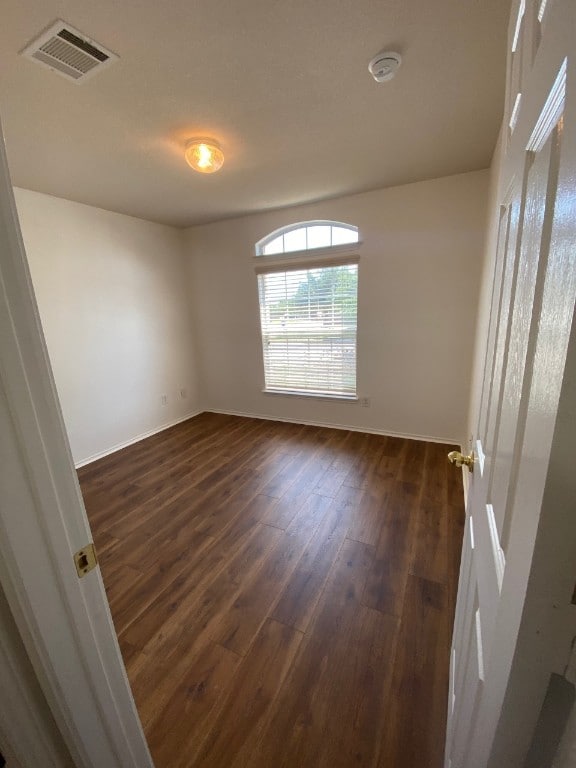 1119 Burgess Dr, Leander, TX 78641 - unfurnished room with a smoke detector and dark wood-type flooring