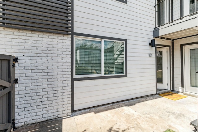 1200 E 52nd St Unit 101, Austin, TX 78723 - doorway to property featuring a patio and brick siding
