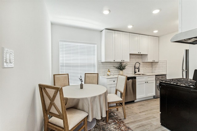 1200 E 52nd St Unit 101, Austin, TX 78723 - kitchen featuring stainless steel dishwasher, a sink, tasteful backsplash, range with gas stovetop, and range hood