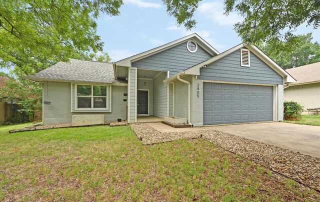 2405 Monarch Dr, Austin, TX 78748 - ranch-style home with a garage, driveway, a front yard, and brick siding