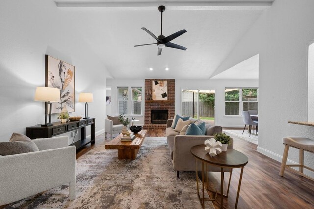 2405 Monarch Dr, Austin, TX 78748 - living room featuring wood finished floors, a ceiling fan, a brick fireplace, baseboards, and beamed ceiling