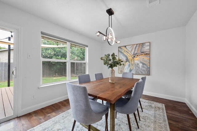 2405 Monarch Dr, Austin, TX 78748 - dining area with baseboards, wood finished floors, and a chandelier