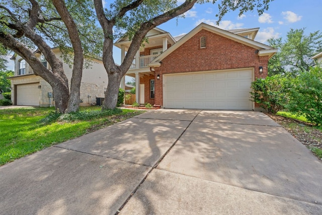 14404 Showdown Ln, Austin, TX 78717 - view of front of home featuring brick siding, concrete driveway, a balcony, and a garage