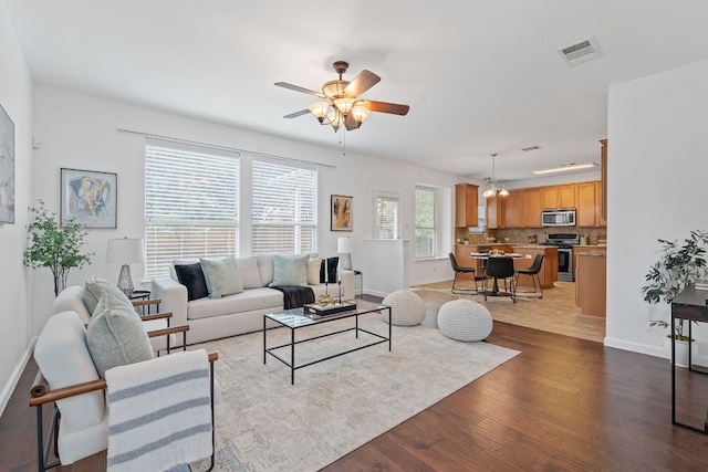 14404 Showdown Ln, Austin, TX 78717 - living room with light wood-style floors, baseboards, ceiling fan, and a chandelier