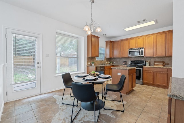 14404 Showdown Ln, Austin, TX 78717 - kitchen featuring stainless steel appliances, plenty of natural light, decorative backsplash, and a sink