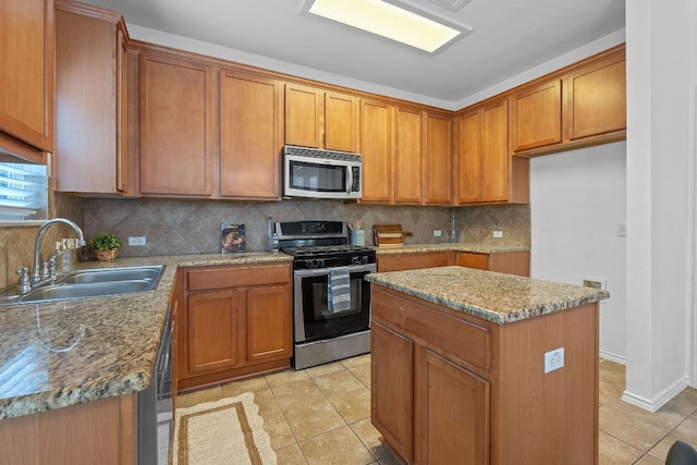 14404 Showdown Ln, Austin, TX 78717 - kitchen featuring appliances with stainless steel finishes, a sink, brown cabinets, light tile patterned floors, and tasteful backsplash
