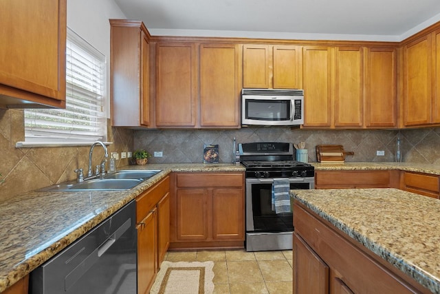 14404 Showdown Ln, Austin, TX 78717 - kitchen with stainless steel appliances, a sink, decorative backsplash, and brown cabinetry