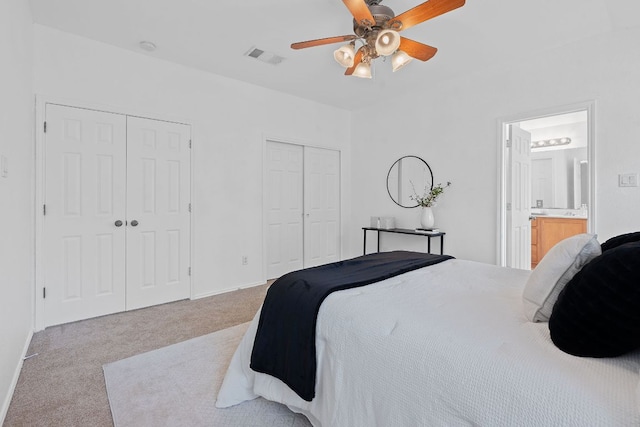 14404 Showdown Ln, Austin, TX 78717 - carpeted bedroom featuring multiple closets, ensuite bathroom, and a ceiling fan