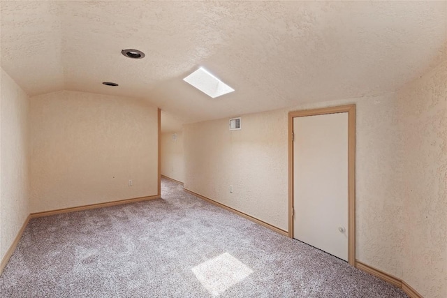 11105 Highview Dr, Belton, TX 76513 - bonus room featuring a textured ceiling, carpet, vaulted ceiling, a textured wall, and a skylight