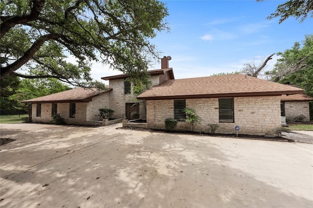 11105 Highview Dr, Belton, TX 76513 - view of front of home with stone siding, a chimney, and a shingled roof