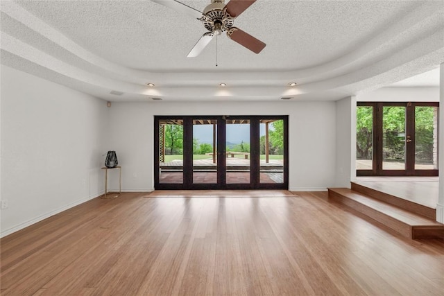 11105 Highview Dr, Belton, TX 76513 - spare room featuring light wood-style flooring, a textured ceiling, french doors, ceiling fan, and baseboards