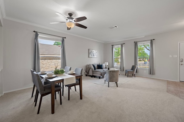 145 Trinity Dr, Kyle, TX 78640 - dining space featuring light carpet, crown molding, ceiling fan, and baseboards
