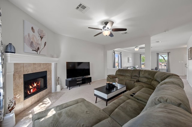 145 Trinity Dr, Kyle, TX 78640 - living room featuring a ceiling fan, a tile fireplace, and carpet floors