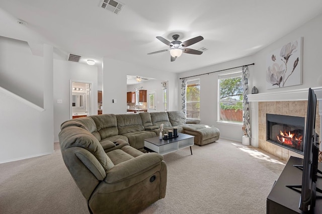 145 Trinity Dr, Kyle, TX 78640 - living room featuring carpet, a ceiling fan, a tile fireplace, and baseboards