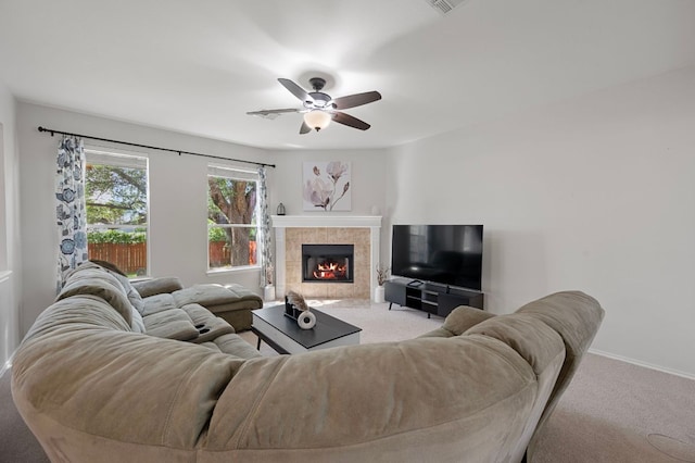 145 Trinity Dr, Kyle, TX 78640 - living room with carpet floors, a ceiling fan, a tile fireplace, and baseboards