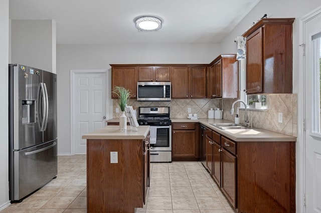 145 Trinity Dr, Kyle, TX 78640 - kitchen with stainless steel appliances, a sink, backsplash, light tile patterned floors, and light countertops