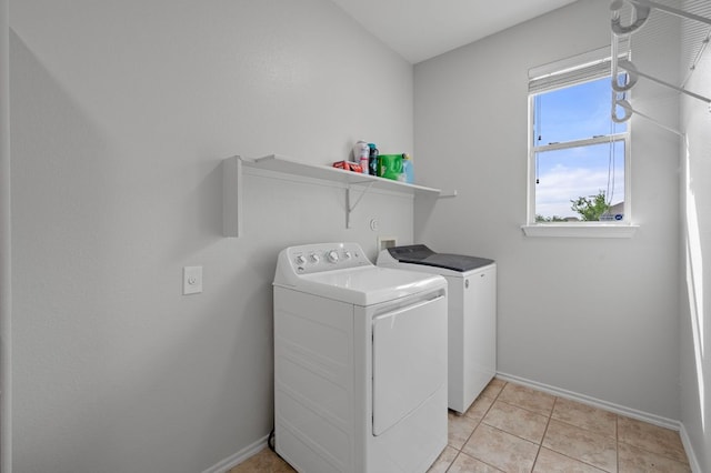 145 Trinity Dr, Kyle, TX 78640 - laundry room featuring independent washer and dryer, baseboards, and light tile patterned flooring