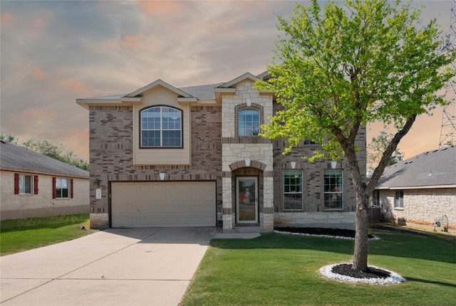 145 Trinity Dr, Kyle, TX 78640 - french provincial home with concrete driveway, a garage, central AC unit, a front yard, and stone siding