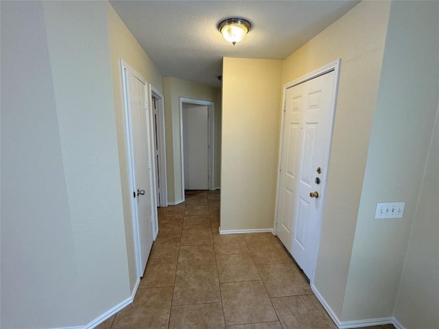 12000 Briarcreek Loop, Manor, TX 78653 - hallway with light tile patterned flooring and baseboards