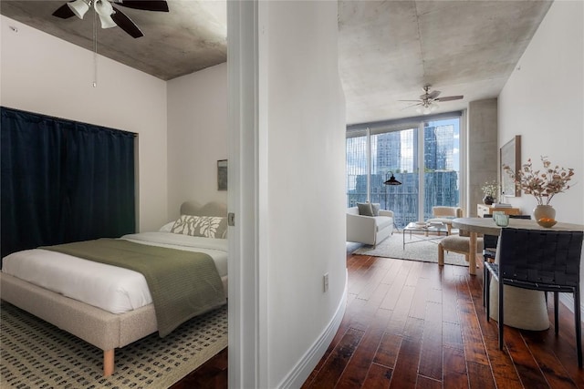 360 Nueces St Unit 1503, Austin, TX 78701 - bedroom featuring dark wood-style flooring, ceiling fan, and baseboards