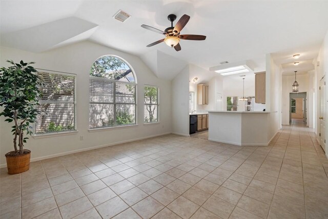 16 Troon Dr, Lakeway, TX 78738 - unfurnished living room featuring healthy amount of natural light, light tile patterned floors, ceiling fan, and vaulted ceiling