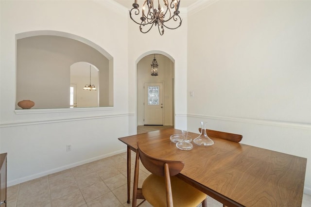 16 Troon Dr, Lakeway, TX 78738 - dining room featuring a chandelier, arched walkways, light tile patterned flooring, a high ceiling, and baseboards