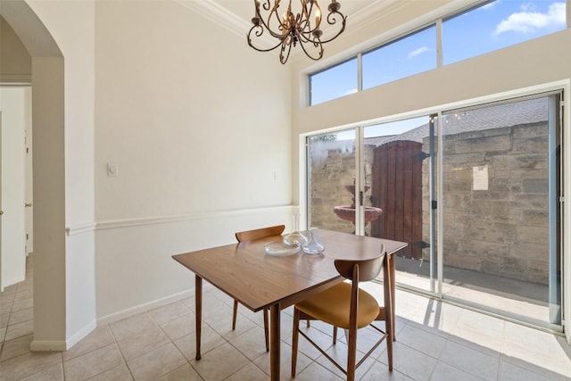 16 Troon Dr, Lakeway, TX 78738 - tiled dining room featuring arched walkways, a chandelier, baseboards, and ornamental molding
