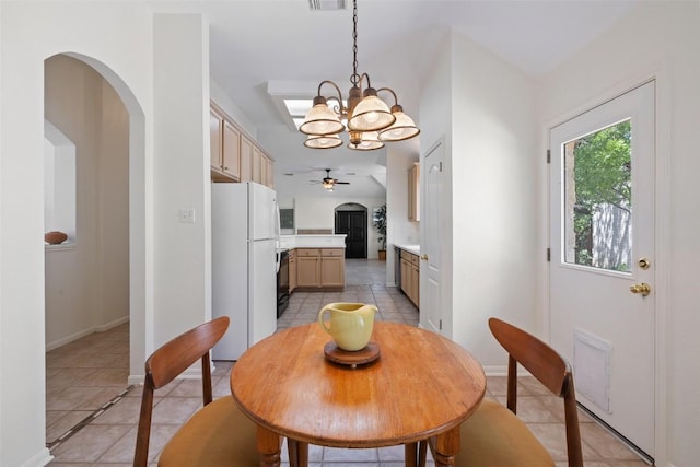 16 Troon Dr, Lakeway, TX 78738 - dining room with a ceiling fan, light tile patterned floors, a chandelier, arched walkways, and baseboards