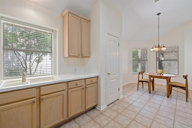 16 Troon Dr, Lakeway, TX 78738 - kitchen with lofted ceiling, a sink, light brown cabinets, light countertops, and a chandelier