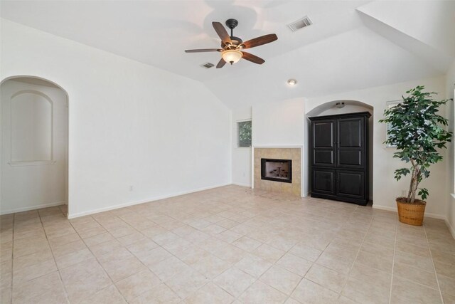 16 Troon Dr, Lakeway, TX 78738 - unfurnished living room with ceiling fan, vaulted ceiling, a fireplace, and light tile patterned floors