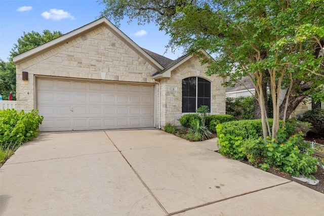 16 Troon Dr, Lakeway, TX 78738 - french provincial home featuring stone siding, concrete driveway, and an attached garage