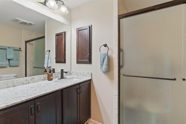 701 W Steele St, Smiley, TX 78159 - full bathroom with vanity, a shower stall, toilet, and baseboards