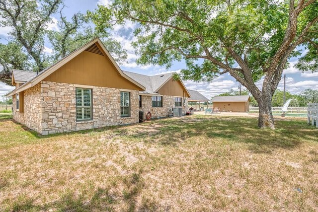 701 W Steele St, Smiley, TX 78159 - back of property with stone siding and central AC unit
