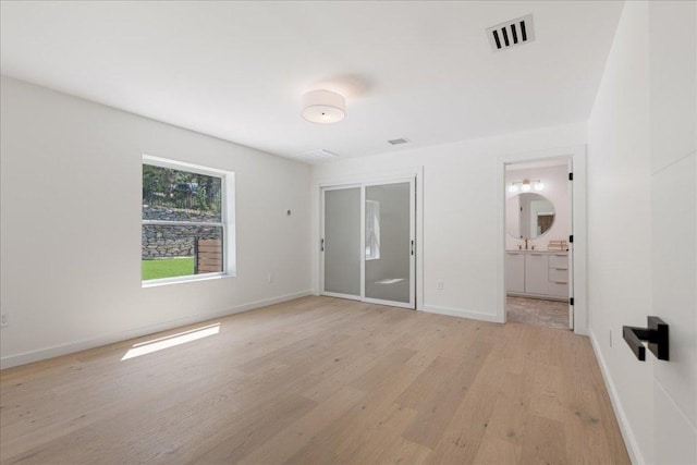 902 Challenger St, Lakeway, TX 78734 - unfurnished bedroom featuring light wood-style floors and ensuite bath