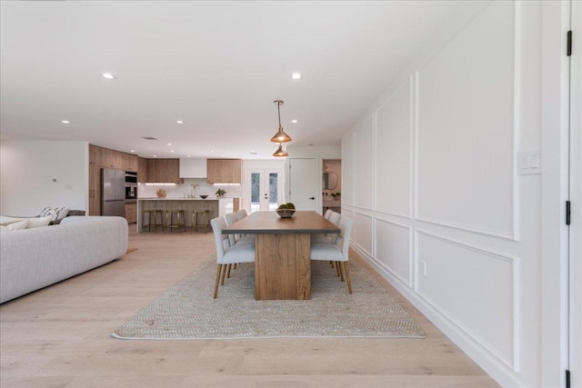 902 Challenger St, Lakeway, TX 78734 - dining space featuring a decorative wall, recessed lighting, french doors, and light wood finished floors