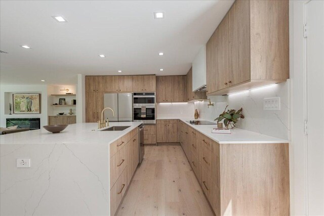902 Challenger St, Lakeway, TX 78734 - kitchen with modern cabinets, stainless steel appliances, a sink, light wood-style flooring, and recessed lighting