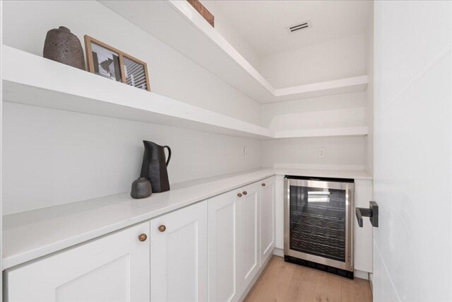 902 Challenger St, Lakeway, TX 78734 - bar area with beverage cooler and light wood-style floors