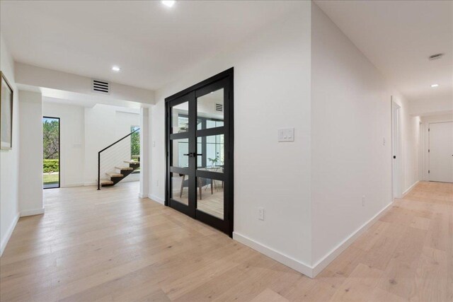 902 Challenger St, Lakeway, TX 78734 - hall featuring light wood-style flooring, stairs, recessed lighting, baseboards, and french doors