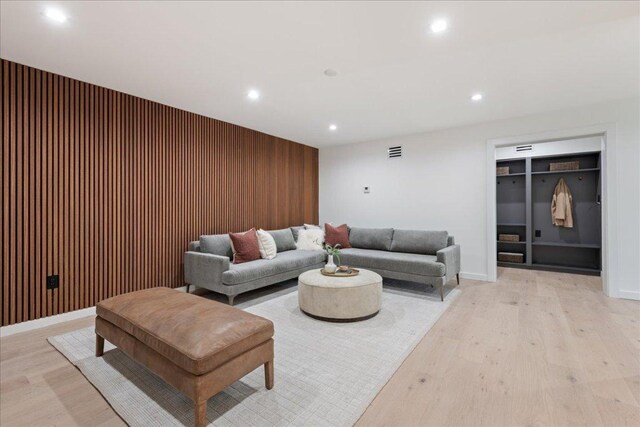 902 Challenger St, Lakeway, TX 78734 - living room featuring recessed lighting, light wood-style flooring, wood walls, and baseboards