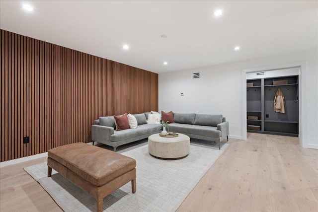 902 Challenger St, Lakeway, TX 78734 - living room with recessed lighting, light wood-style flooring, wooden walls, and an accent wall