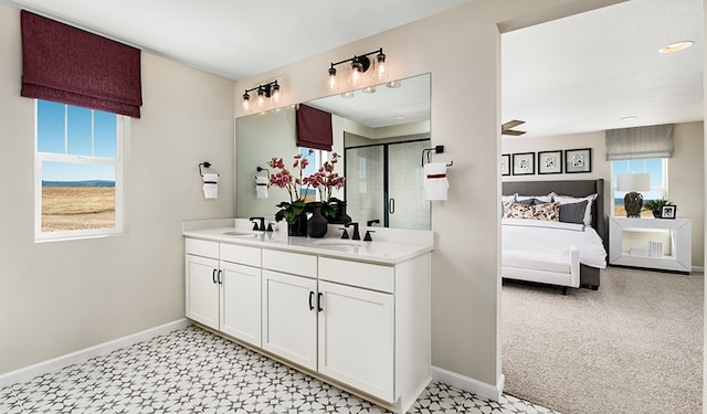 20600 Ed Townes Ter, Manor, TX 78653 - ensuite bathroom featuring plenty of natural light, baseboards, and double vanity